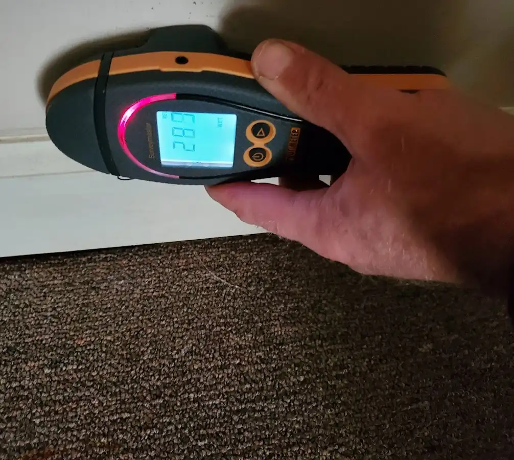 Moisture detection at baseboard during Storm Damage Restoration in Bridgeport
